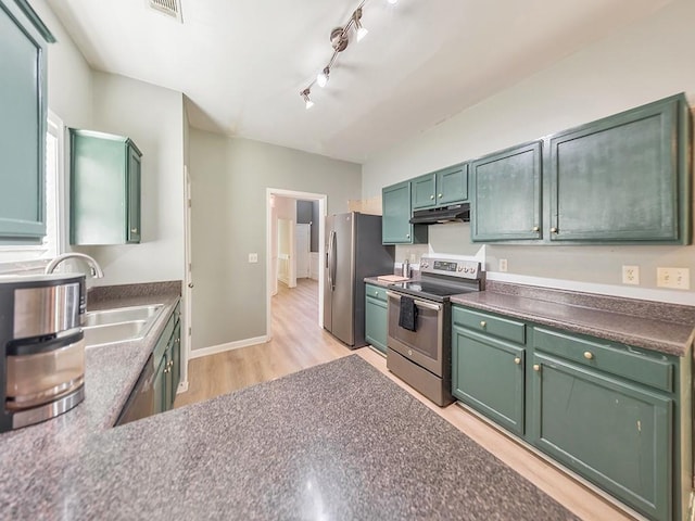 388 Oakhaven Way, Villa Rica, GA 30180 - kitchen featuring a sink, green cabinets, appliances with stainless steel finishes, light wood-style flooring, and under cabinet range hood