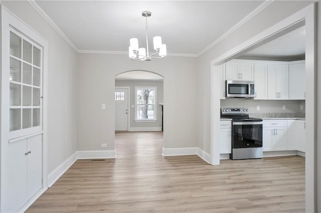 kitchen featuring arched walkways, a chandelier, appliances with stainless steel finishes, white cabinets, and light wood-type flooring