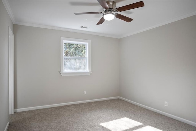 carpeted spare room featuring visible vents, ceiling fan, and baseboards