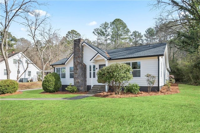 ranch-style home with a chimney, central AC unit, and a front yard