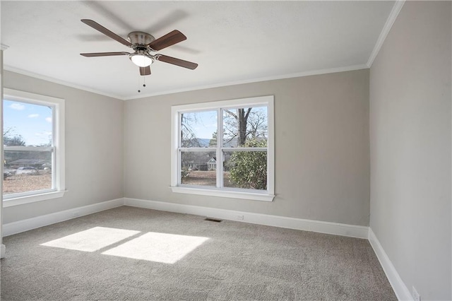 carpeted empty room featuring visible vents, ceiling fan, ornamental molding, and baseboards