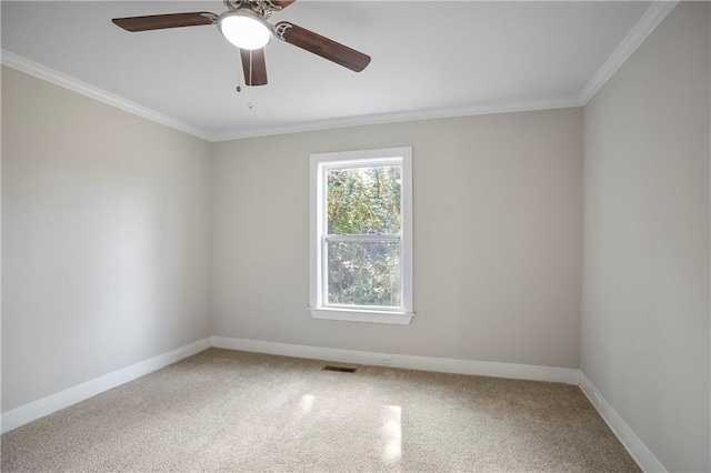 spare room with light colored carpet, visible vents, ornamental molding, and baseboards
