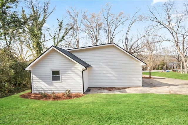 view of side of home with a yard