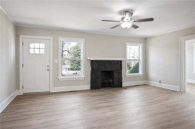 unfurnished living room featuring ceiling fan, ornamental molding, and baseboards