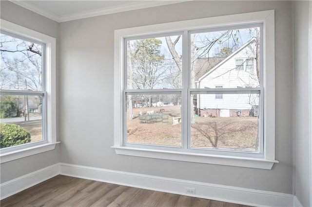 interior details with baseboards, ornamental molding, and wood finished floors