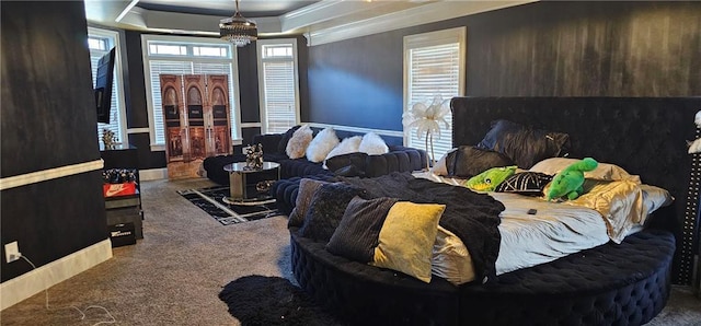 bedroom featuring ornamental molding, a raised ceiling, and carpet