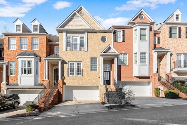 townhome / multi-family property with a garage, concrete driveway, and brick siding