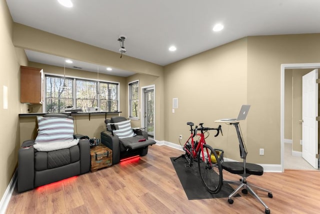 workout area featuring light wood-style flooring, baseboards, and recessed lighting