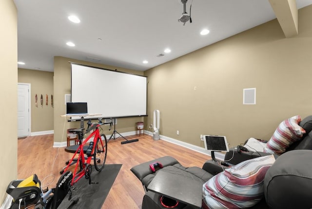 home theater room featuring recessed lighting, baseboards, and wood finished floors