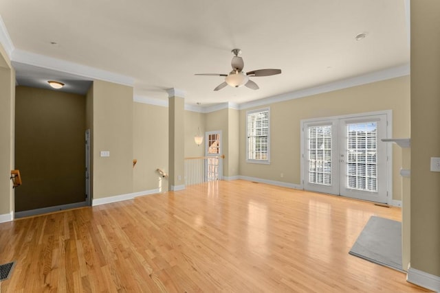 unfurnished living room with ceiling fan, baseboards, crown molding, and wood finished floors