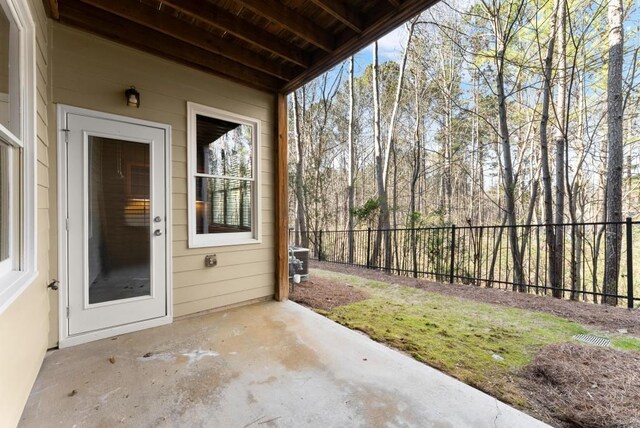 exterior space with central AC and fence