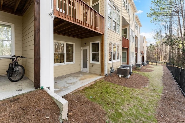 exterior space featuring a patio, fence, and central air condition unit