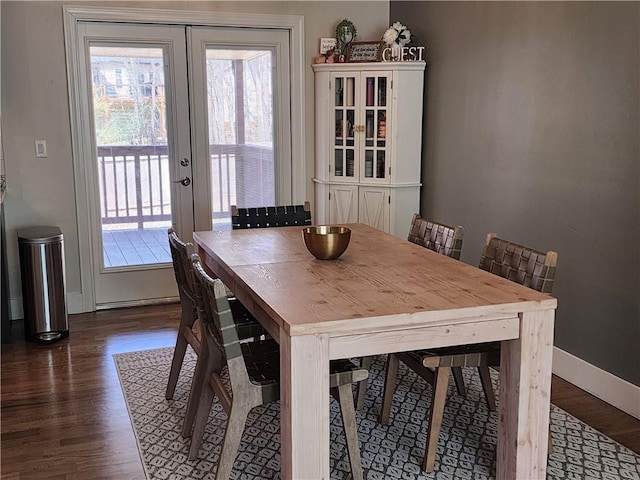 dining room featuring french doors, dark wood-type flooring, and baseboards