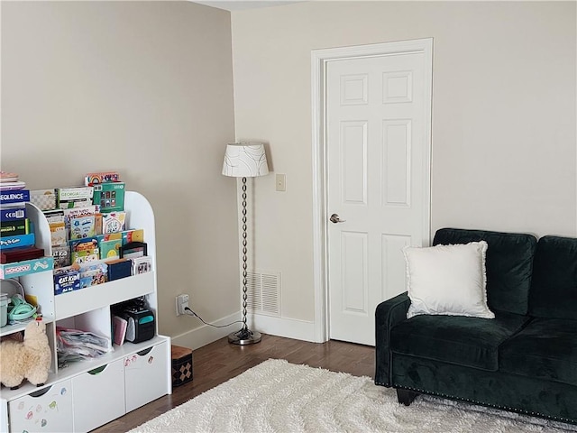 interior space featuring wood finished floors, visible vents, and baseboards