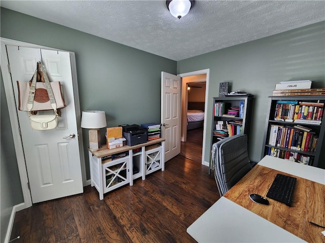 home office featuring a textured ceiling, wood finished floors, and baseboards