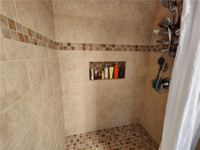 full bathroom with tiled shower