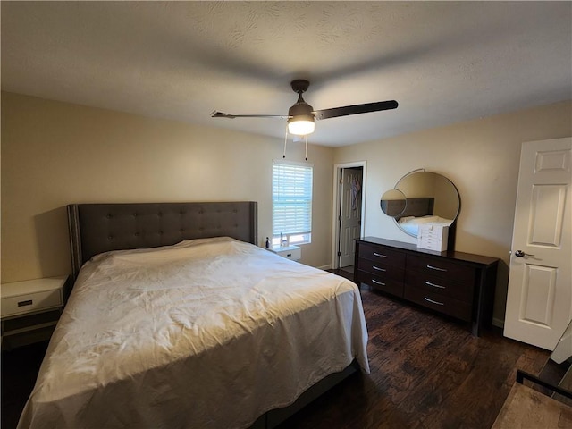 bedroom featuring a ceiling fan, dark wood-style flooring, a textured ceiling, and baseboards