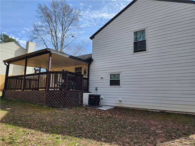 back of house with central AC and a wooden deck