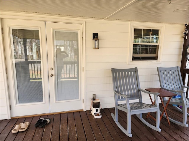 view of exterior entry featuring a wooden deck