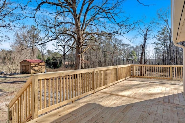 wooden terrace with an outdoor structure and a storage shed