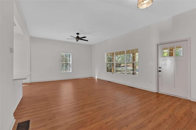 entrance foyer with light wood-type flooring, baseboards, visible vents, and a ceiling fan