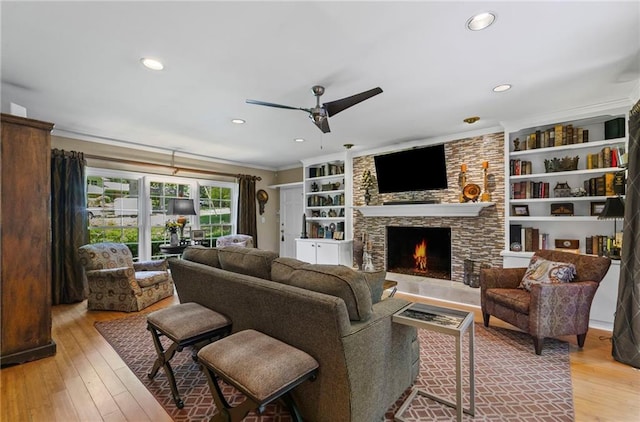 3287 Alton Rd, Atlanta, GA 30341 - living room featuring a ceiling fan, a stone fireplace, light wood finished floors, ornamental molding, and recessed lighting