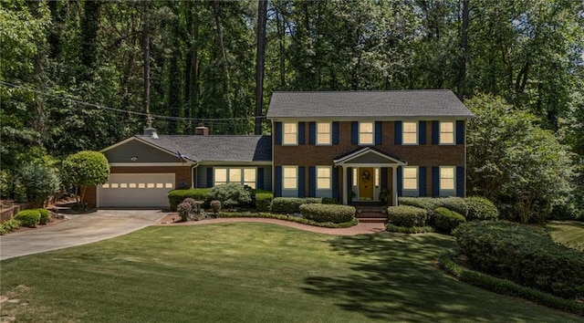 3287 Alton Rd, Atlanta, GA 30341 - colonial home with concrete driveway, a garage, a front yard, and brick siding