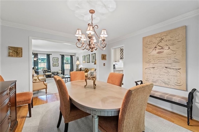 3287 Alton Rd, Atlanta, GA 30341 - dining space with light wood finished floors, crown molding, and a chandelier