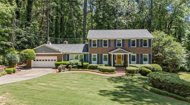 3287 Alton Rd, Atlanta, GA 30341 - colonial house featuring concrete driveway, an attached garage, a front yard, brick siding, and a chimney