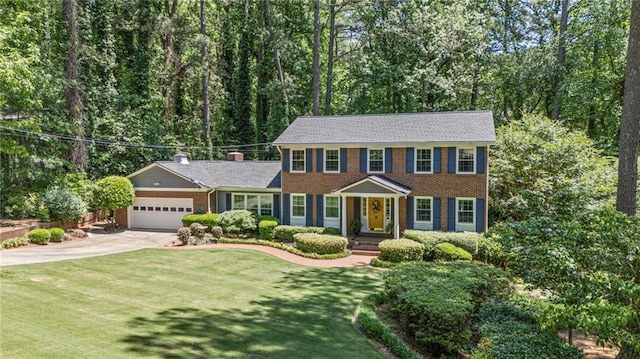 3287 Alton Rd, Atlanta, GA 30341 - colonial-style house featuring driveway, an attached garage, brick siding, and a front lawn