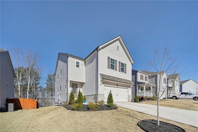 view of front of home with central AC unit and a garage