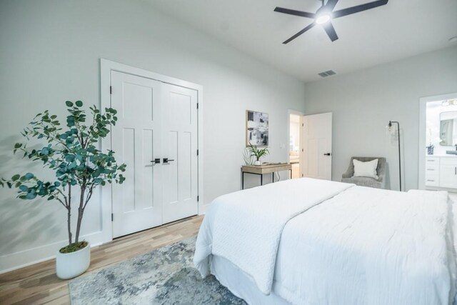 bedroom with light hardwood / wood-style flooring, ceiling fan, and a closet