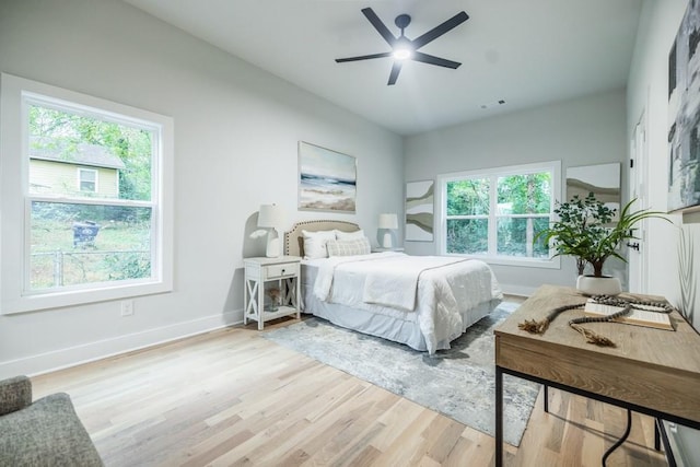 bedroom with light hardwood / wood-style floors, multiple windows, and ceiling fan