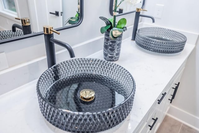 interior details featuring sink and tile patterned floors