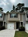 bi-level home featuring an attached garage and driveway