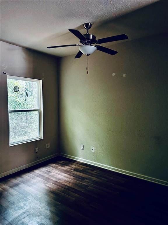 unfurnished room with baseboards, a textured ceiling, ceiling fan, and wood finished floors