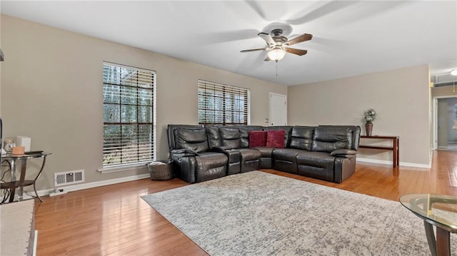 living room with hardwood / wood-style flooring and ceiling fan