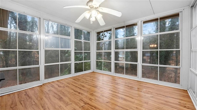 unfurnished sunroom with ceiling fan