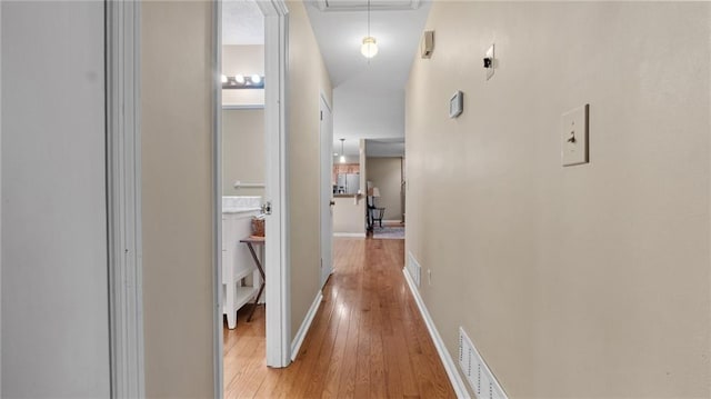 hall with light hardwood / wood-style floors