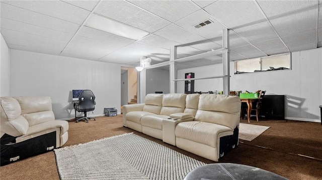 living room with a drop ceiling