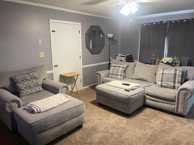 carpeted living room with ceiling fan, crown molding, and a textured ceiling