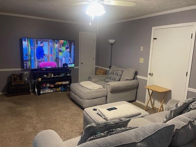 carpeted living room with crown molding, a textured ceiling, and ceiling fan