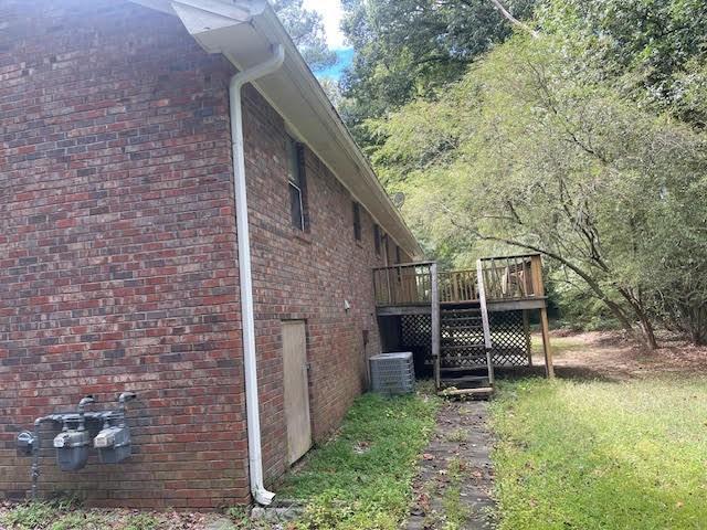 view of home's exterior featuring a wooden deck and central AC unit