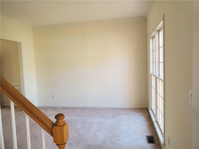 unfurnished room with crown molding