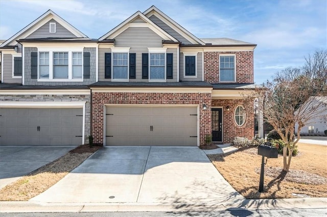 view of property featuring a garage, concrete driveway, and brick siding