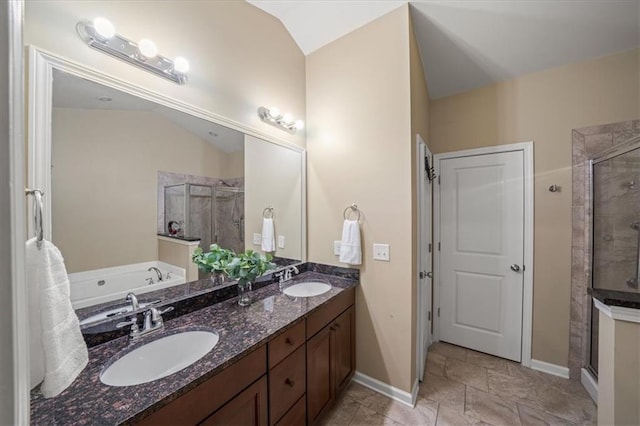 full bath with a bath, a shower stall, double vanity, and a sink