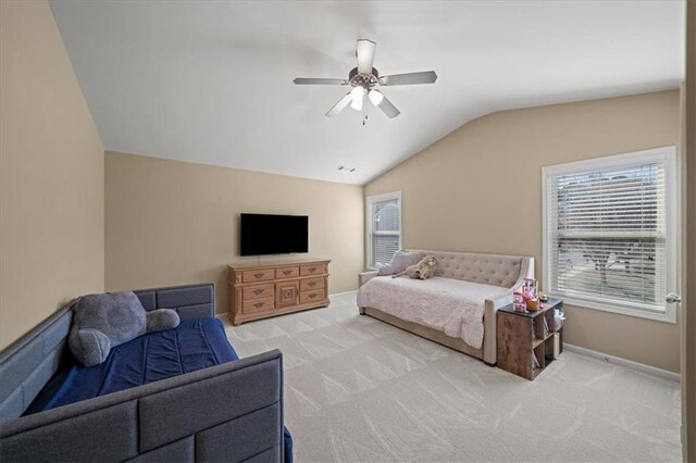 bedroom with a ceiling fan, lofted ceiling, light colored carpet, and baseboards