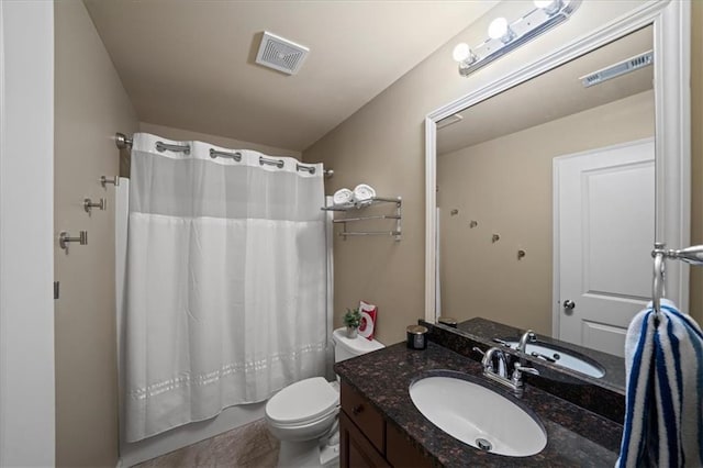 bathroom with toilet, shower / tub combo, vanity, and visible vents