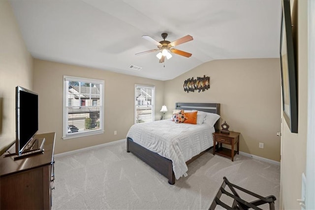 carpeted bedroom with baseboards, visible vents, vaulted ceiling, and a ceiling fan