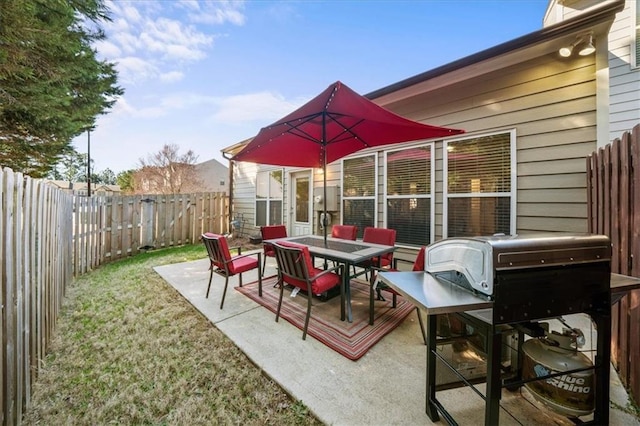 view of patio / terrace with outdoor dining space, area for grilling, and a fenced backyard